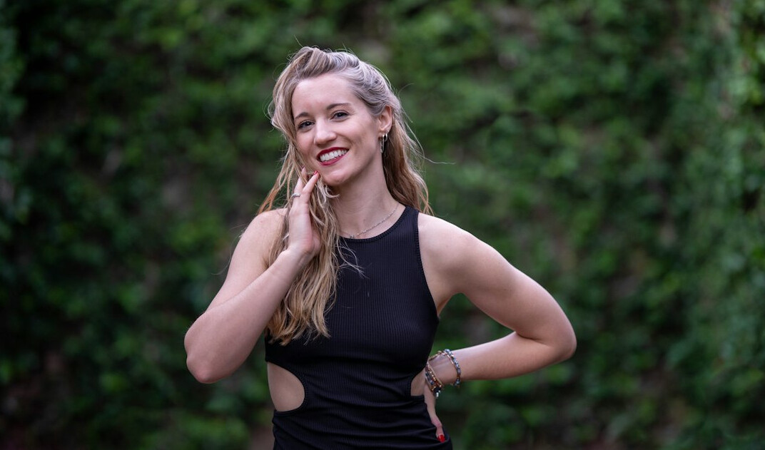 Professional headshot of a Eurasian female corporate wellness trainer
